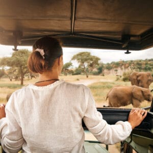 WomanTouristOnASafariInAfricaTravelingByCar