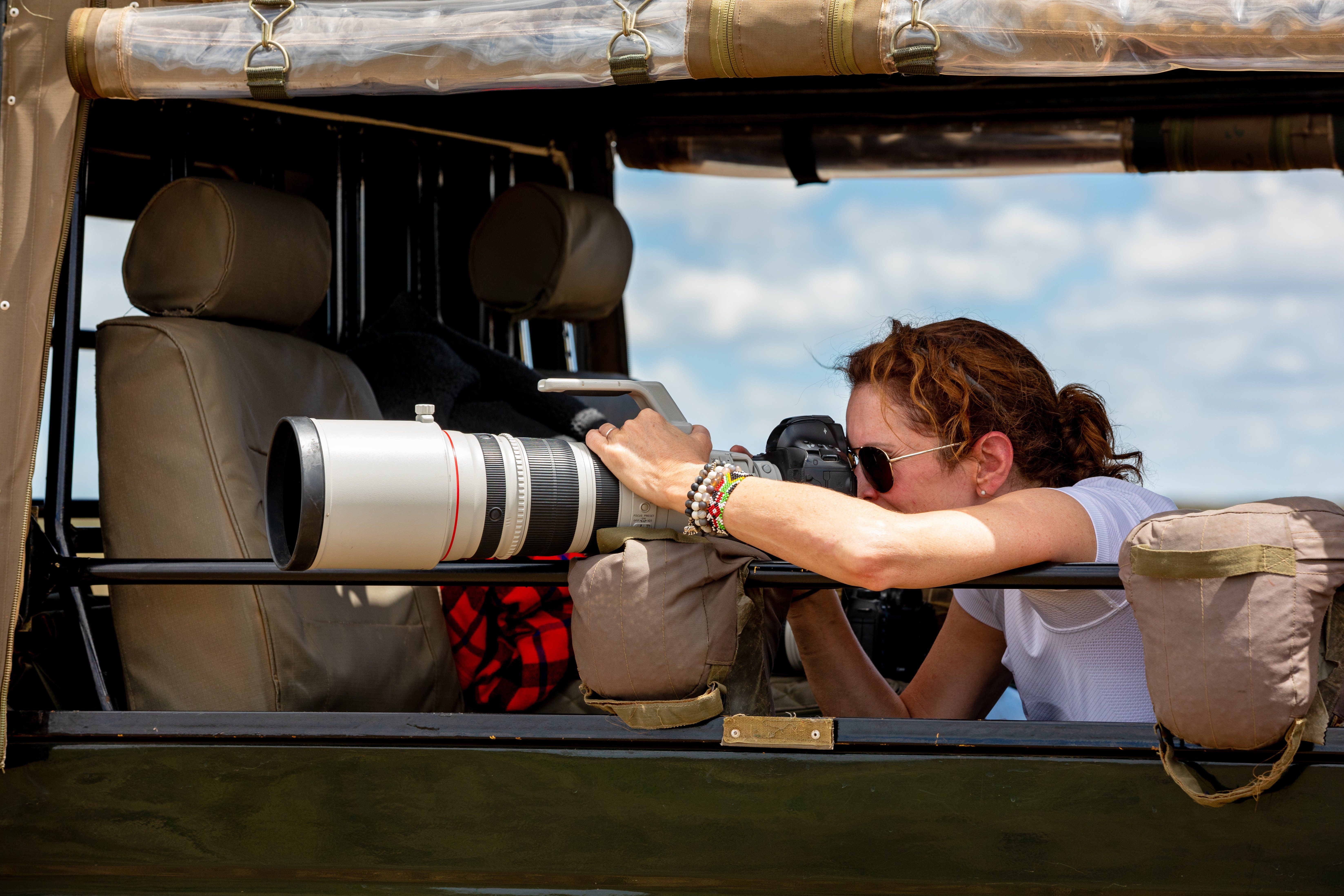 Female,Professional,Photographer,On,Safari.,Woman,Rests,Camera,On,A » Tembo Safari