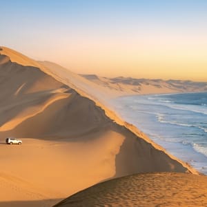 CarInTheSandDunesAndOceanViewInSandwich